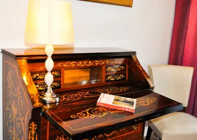 a desk with a lamp and a book on it at Trastevere Boulevard in Rome