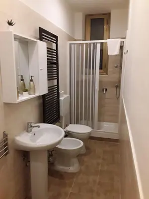 a bathroom with a toilet and a sink and a shower at Monia Coliseum Apartment in Rome