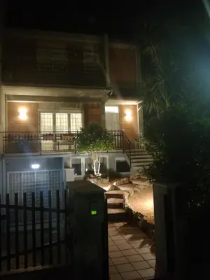 a house at night with a fence in front of it at La camelia bianca in Rome