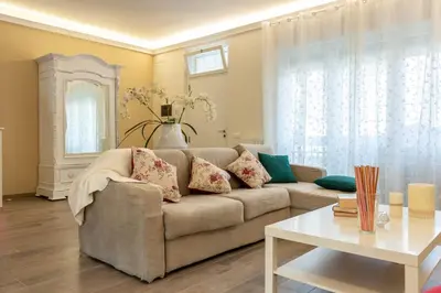 a living room with a couch and a table at La camelia bianca in Rome