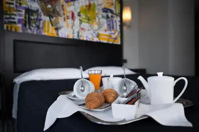 a tray of food with croissants and cups on a table at Twentyone Hotel in Rome