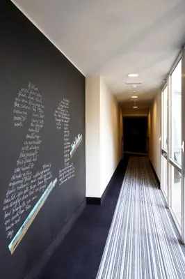 a hallway with a wall with writing on it at Twentyone Hotel in Rome