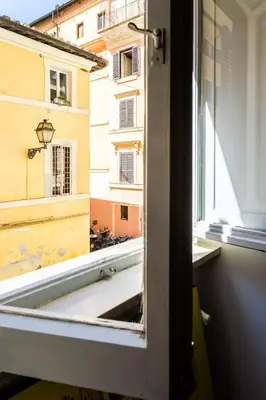 an open window with a view of a building at Domus Maya Colosseum in Rome