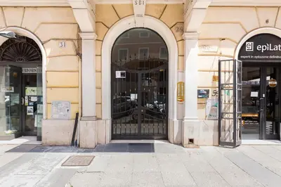 a store front with a gate in a building at BMGA l Central Holiday House 2Bdr near Vatican in Rome