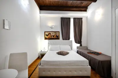 a bedroom with a bed and a window at Roman Nights in Rome