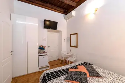 a bedroom with a bed and a small table at Roman Nights in Rome