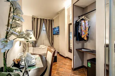 a living room with a table and a room with a couch at Boutique Relais Barozzi & SPA in Rome