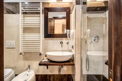 a bathroom with a sink and a mirror at Boutique Relais Barozzi & SPA in Rome