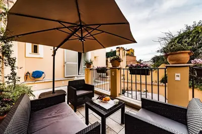 a patio with an umbrella and a table at Dolcevita Apartments in Rome