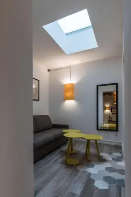 a living room with a couch and a table at Dolcevita Apartments in Rome