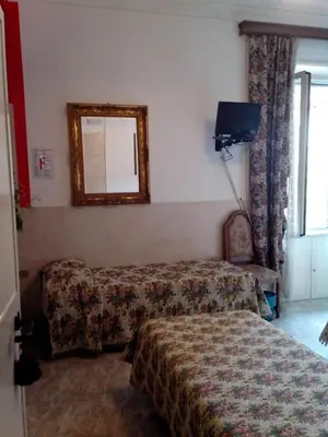 a hotel room with a bed and a mirror at Hotel Stadler 2 in Rome