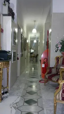 a hallway of a building with chairs and a room at Hotel Stadler 2 in Rome