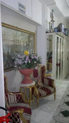 a room with two chairs and a vase of flowers at Hotel Stadler 2 in Rome