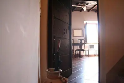 a hallway with a plant in a pot next to a door at Portico d'Ottavia, the ancient Rome in Rome