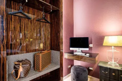 a room with a desk with a computer and a chair at The Brunetti - Luxury serviced apartment in Rome