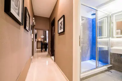 a hallway with a shower and a window at The Brunetti - Luxury serviced apartment in Rome