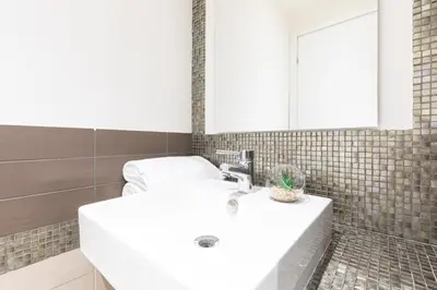 a bathroom with a white sink and a mirror at Cesar Vatican Rooms in Rome