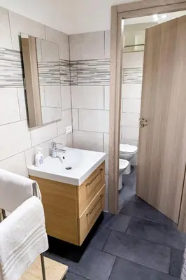 a bathroom with a sink and a toilet at Sannio Apartment - near Metro San Giovanni by RHR in Rome