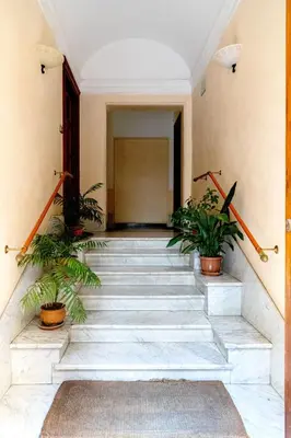 a staircase in a building with potted plants at Sannio Apartment - near Metro San Giovanni by RHR in Rome