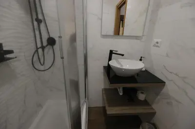 a white bathroom with a sink and a shower at B&B A Picture of Rome in Rome
