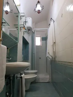 a bathroom with a sink and a toilet and a mirror at APPARTAMENTO SIMONE DUE in Rome