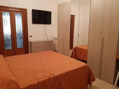 a bedroom with a bed and a flat screen tv at APPARTAMENTO SIMONE DUE in Rome