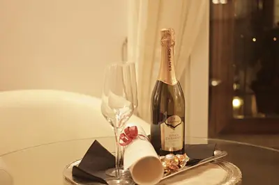 a bottle of champagne and a glass on a table at Locanda Navona in Rome