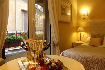 a hotel room with a bed and a vase on a table at Locanda Navona in Rome