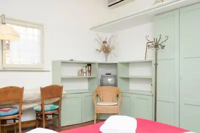 a room with a table and two chairs and a television at Coliseum top floor with terrace and view in Rome