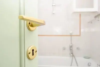 a bathroom with a shower and a door with a handle at Coliseum top floor with terrace and view in Rome