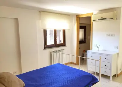 a bedroom with a bed with a blue blanket at Aurelia House in Rome
