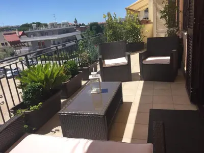a patio with chairs and a table on a balcony at Aurelia House in Rome
