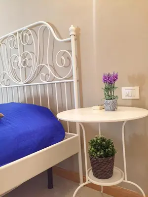 a bedroom with a bed and a table with a plant at Aurelia House in Rome