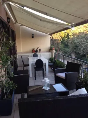 a patio with a table and chairs on a balcony at Aurelia House in Rome