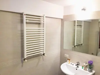 a bathroom with a sink and a mirror at Aurelia House in Rome