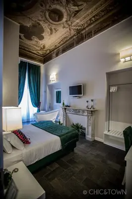 a hotel room with a bed and a bath tub at Chic & Town Luxury Rooms Piazza di Spagna in Rome