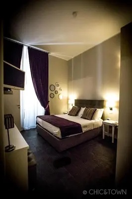 a bedroom with a large bed and a window at Chic & Town Luxury Rooms Piazza di Spagna in Rome
