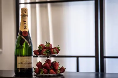 a bottle of champagne and strawberries on a table at Chic & Town Luxury Rooms Piazza di Spagna in Rome