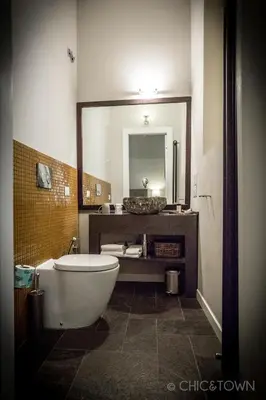 a bathroom with a tub and a sink and a mirror at Chic & Town Luxury Rooms Piazza di Spagna in Rome