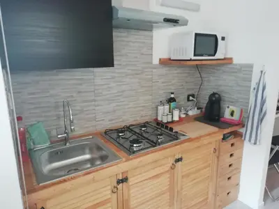 a kitchen with a sink and a stove at Gianicolo Country Room in Rome