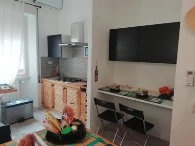 a kitchen with a table and chairs in a room at Gianicolo Country Room in Rome