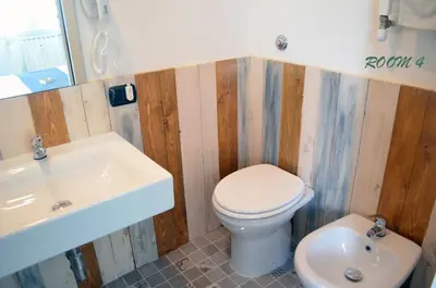 a bathroom with a toilet and a sink at Gianicolo Country Room in Rome
