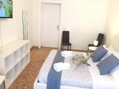 a bedroom with a bed with two towels on it at RELAX INN VATICAN in Rome