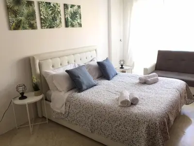 a bedroom with a bed with blue and white pillows at RELAX INN VATICAN in Rome