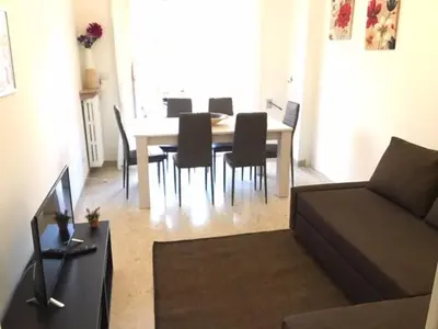 a living room with a table and chairs and a couch at RELAX INN VATICAN in Rome