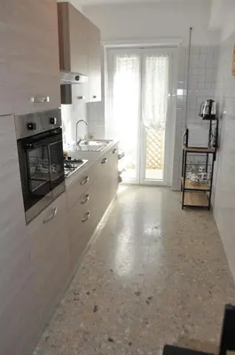 a kitchen with a sink and a stove top oven at RELAX INN VATICAN in Rome