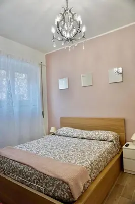 a bedroom with a bed and a chandelier at Home Vatican Star in Rome