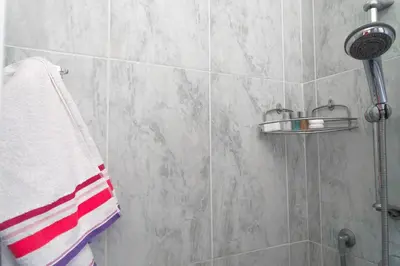 a bathroom with a shower with a towel on a wall at The Condottieri in Rome
