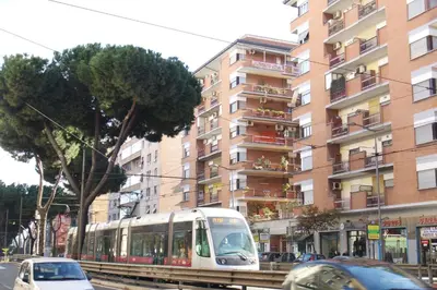a tram on a street in front of a tall building at The Condottieri in Rome