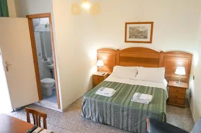 a hotel room with a bed and a bathroom at The Condottieri in Rome